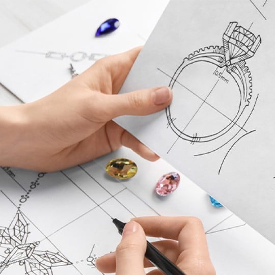 Image of person drawing concepts of jewellery on paper