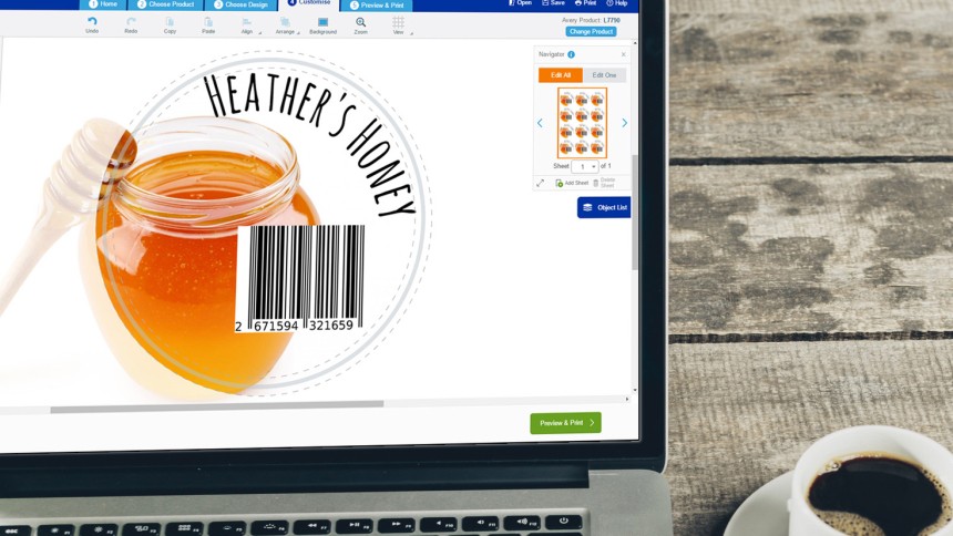 Laptop screen next to a cup of coffee, showing a honey image, text reading heather's hone, and a barcode.