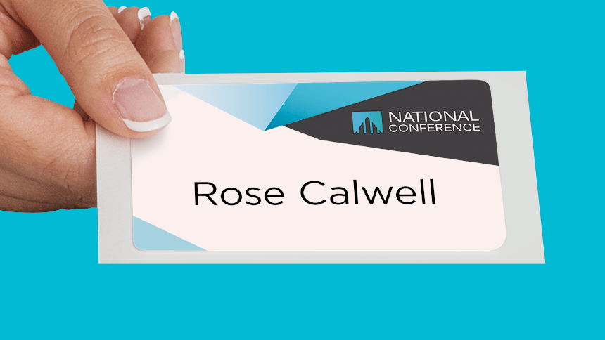 A hand with manicured fingernails holds a name tag that reads "Rose Calwell." The top of the name tag has a modern design with white, gray, and blue geometric shapes and the logo for "National Company."