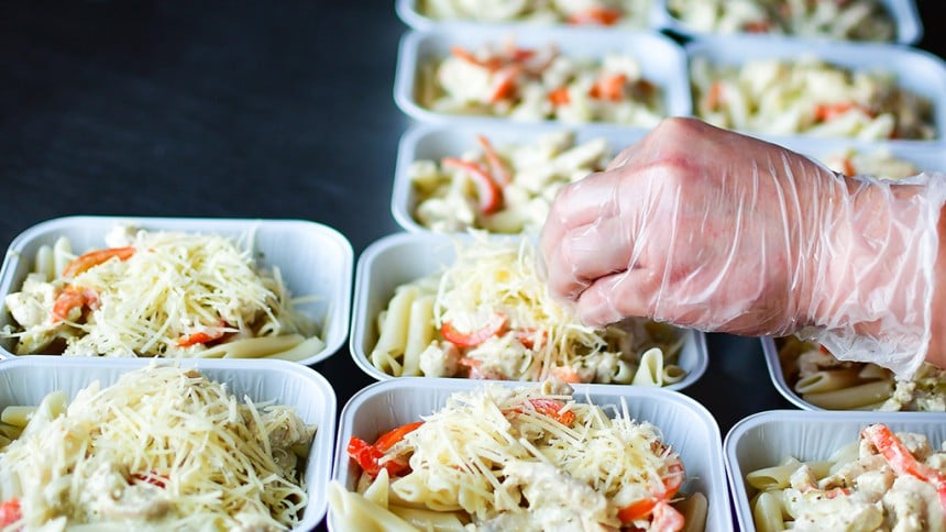 Image of a someone preparing food in some containers