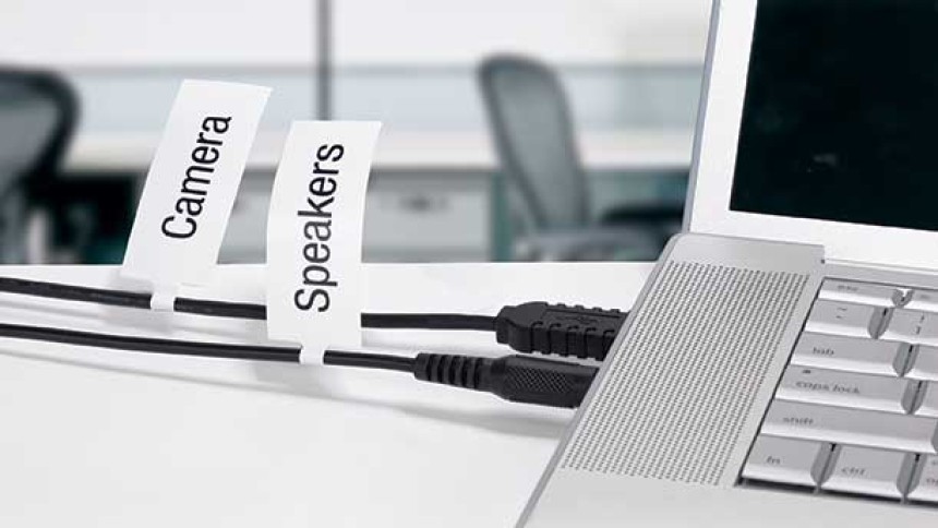 Cable Marker Labels attached to a computer on a desk in an office