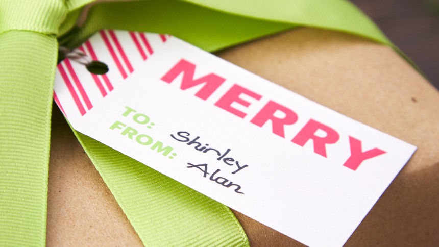 Red and White stripped Printable Gift Tags with the words Merry to Shirtley from Alan on a present with a green bow