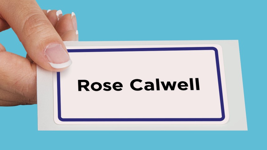 Hand holding a name tag with a border