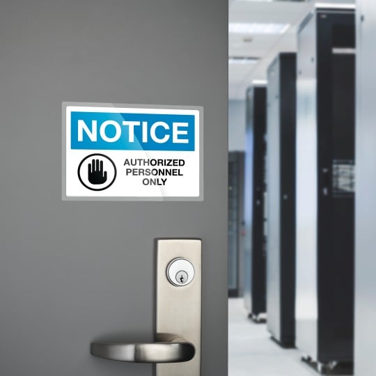 Laminated Labels on a door that reads Notice Authorised Personnel Only
