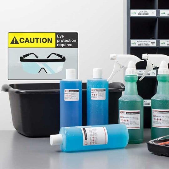 Ultra Heavy Duty Labels in Bottles next to a Safety Google