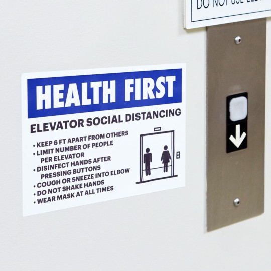 Signs on Elevator with diagram asking people to social distance and keep a distance.