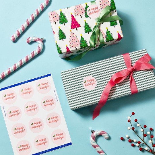 Round labels on sheets with colourful christmas gifts with labels and bows on a light blue background