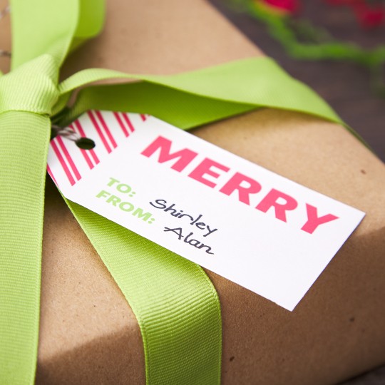 Red and White stripped Printable Gift Tags with the words Merry to Shirtley from Alan on a present with a green bow
