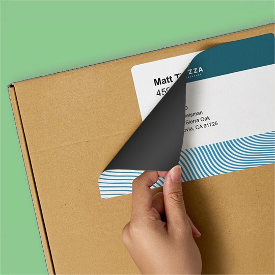 person placing trueblock label on existing label