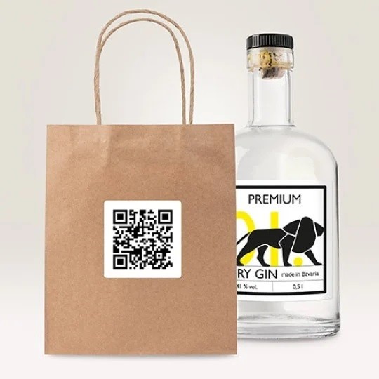 QR code stickers on a brown paper bag with a bottle of spirit in the background