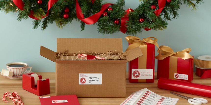 Christmas Gift wrapping with printed labels in sheets cut out for presents, boxes and Christmas cards.
