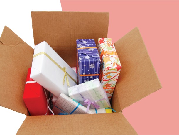 Multiple gift wrapped boxes piled high within an open brown carton.