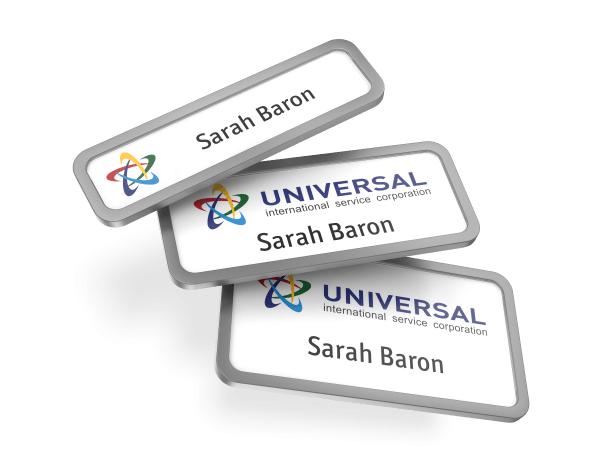 Three different size name badges with a name printed on the inserts.