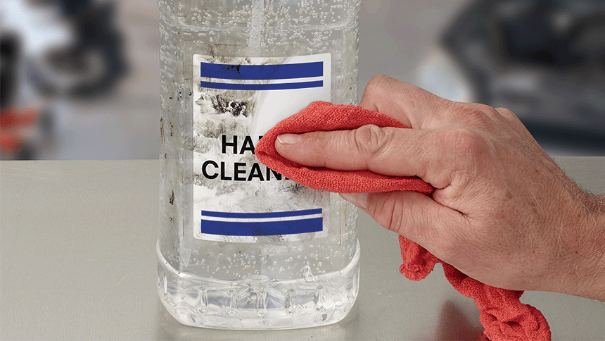 Heavy Duty Label on a bottle being wiped clean