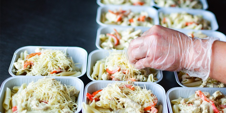 Image of a someone preparing food in some containers
