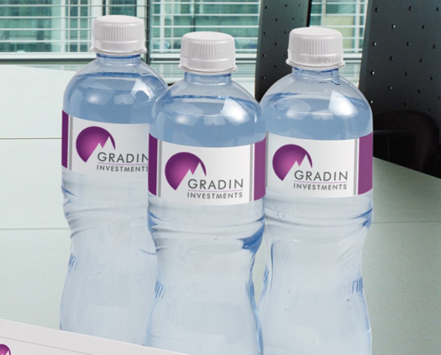Plastic water bottles with corporate branded labels on them