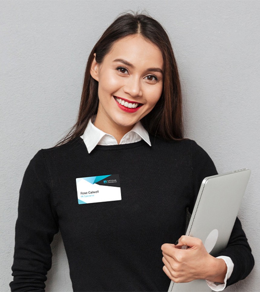 Smiling woman with a fabric name badge on her sweater