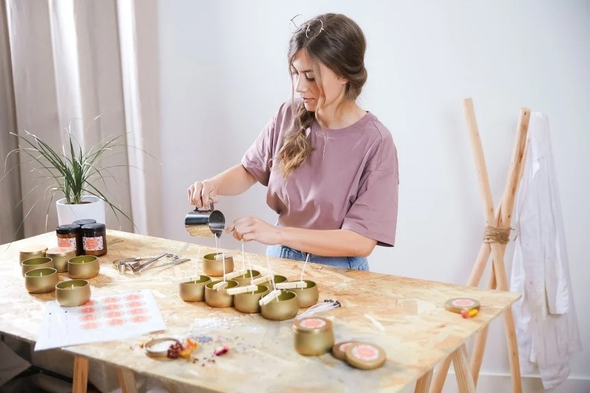 Candle Business owner puring wax and labeling her candle products