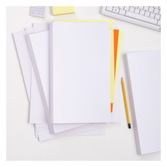 The image shows a collection of blank sheets of paper arranged on a desk, including various colored sheets such as yellow and orange. There is a yellow pencil and a keyboard in the background, along with a calculator and a sticky note.