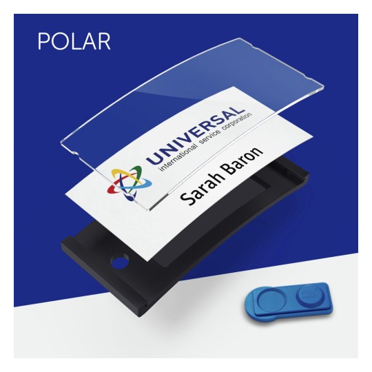 The image features a name badge setup. It includes a clear plastic cover, a white badge displaying the name 'Sarah Baron' and the logo of 'UNIVERSAL international service corporation.' A blue button is also present, likely for securing the badge.