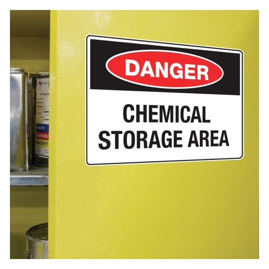 The image shows a bright yellow cabinet with a sign that reads 'DANGER CHEMICAL STORAGE AREA.' It indicates a place where chemicals are stored, warning against potential hazards.