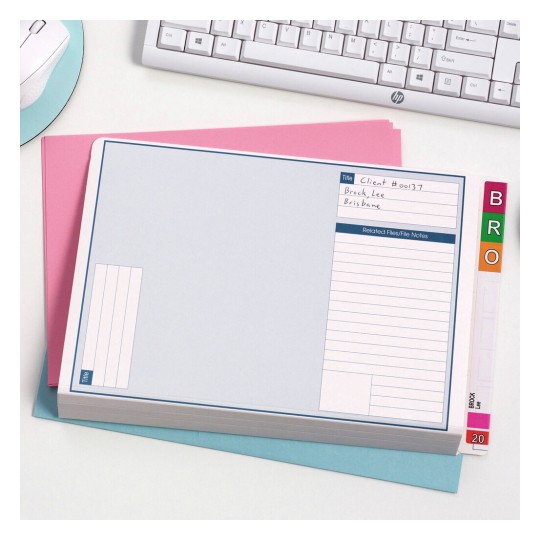 The image shows an organized folder or file with a title section and notes. It is placed on colored paper, a computer keyboard, and a mouse can be seen in the background.