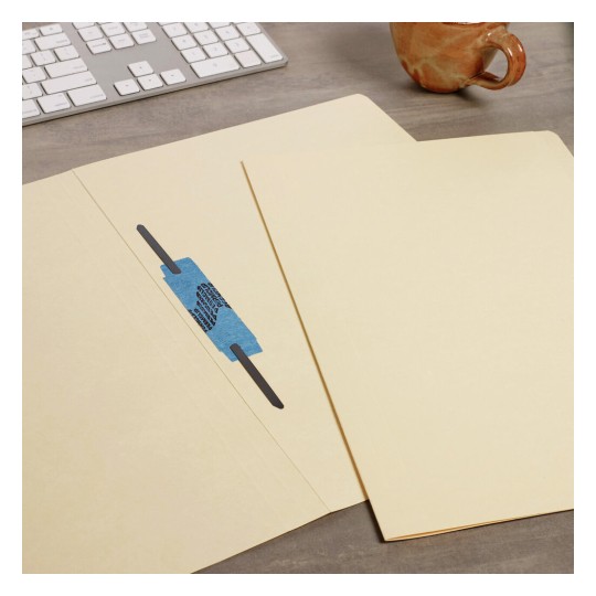 The image shows a workspace with a light-colored file folder, a piece of blue tape, and a keyboard in the background. A mug is also visible on the table.