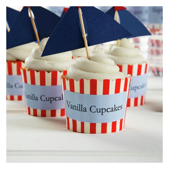 The image features several vanilla cupcakes with white frosting, sitting in red and white striped cups. Each cupcake has a small blue flag with the text 'Vanilla Cupcakes'.