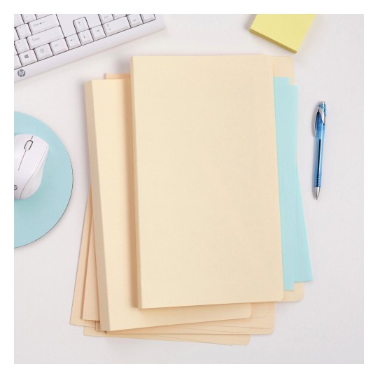 The image features a set of colored folders stacked on a desk. There is a computer keyboard, a mouse, and a pen nearby, along with a small pad of sticky notes. The background is minimalistic.