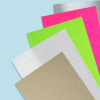 This image features many blank samples of labels spread diagonally. They all; have different colours and shapes. Colours include Kraft brown , gloss, fluoro green, hot pink and metallic silver
