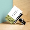 Business cards in a pile held together by a bull dog clip.