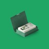 Custom printed business cards in a green business card box on a green flat background