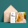 A6 postcard leaning against a blush coloured envelope. The custom printed postcard has a picture of a young women and is an invitation for a graduation