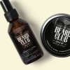Custom printed labels applied to oil dropper bottle and tin for a beard health brand.
