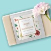 Custom printed label stuck on a cardboard sleeve around a soap. The label design has flowers and says Rose and Magnolia.