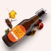 Oval Label applied to a brown craft cider bottle. The label is bright orange with the words "Sunrise Mellow, Irish Cider"