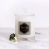 Glass candle jar with black and white geometric label design.