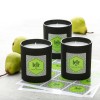 3 black candle jars with geometric green labels applied. The flavour is French Pear.  Under the jars are the sheets of labels. And behind the jars are some pears.