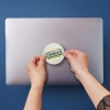 Sticker being applied to laptop