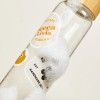 Clear drink bottle with different stickers applied and then bubbles as if being washed.