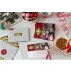 Christmas Card on table with hand written message, shipping labels, cookies and Christmas decoration
