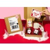 Gift Hamper with thank you card and an assortment of gifts like tea sachet, mug, honey and chocolate all with different sized and shaped product labels.
