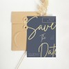 Save the Date Wedding Card gold cursive font on a dark blue background.