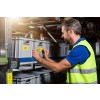 Man applying label to tubs in warehouse