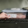 The image shows a container of chicken in a refrigerated environment, with a label detailing preparation and expiration dates, and an employee's name.