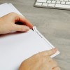 The image shows a hand holding a tab on a file labeled 'Customer File: Don Matthews', with a keyboard in the background.
