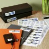 The image features various folders and labels related to financial documents such as tax claims, budgets, invoices, and quotes. A calculator is also visible, alongside neatly organized papers and a device, likely for digital storage.