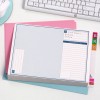 The image shows an organized folder or file with a title section and notes. It is placed on colored paper, a computer keyboard, and a mouse can be seen in the background.