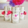 The image features three silver tea tins labeled 'Bride to be Jasmine Tea'. Each tin is decorated with a pink and purple design and adorned with a small pink watering can. The background has soft colors, enhancing a festive atmosphere.