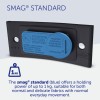 The image shows the SMAG® Standard device, which is blue and has a holding power of up to 1 kg. It's designed for use with normal and delicate fabrics with everyday movements. It includes safety warnings regarding use with cardiac pacemakers.